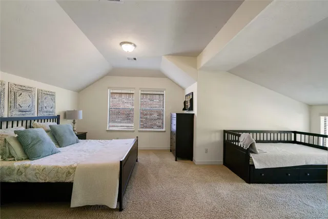 a spacious bedroom with a bed and a large window