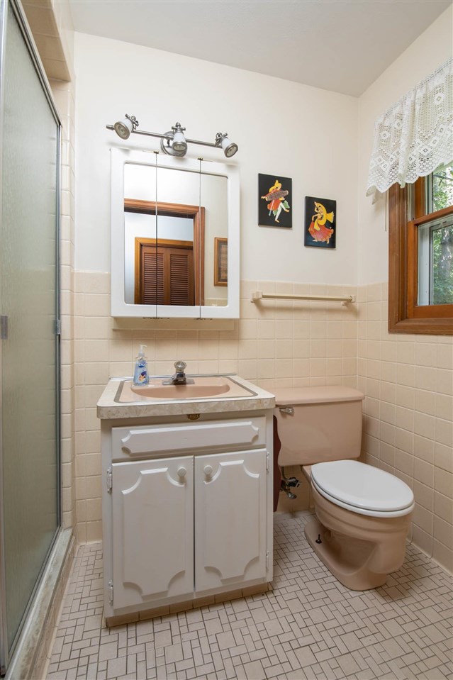 4960 Welsh Road Rockford, IL 61107 - Photo 17 of 39 a bathroom with a toilet a sink and mirror
