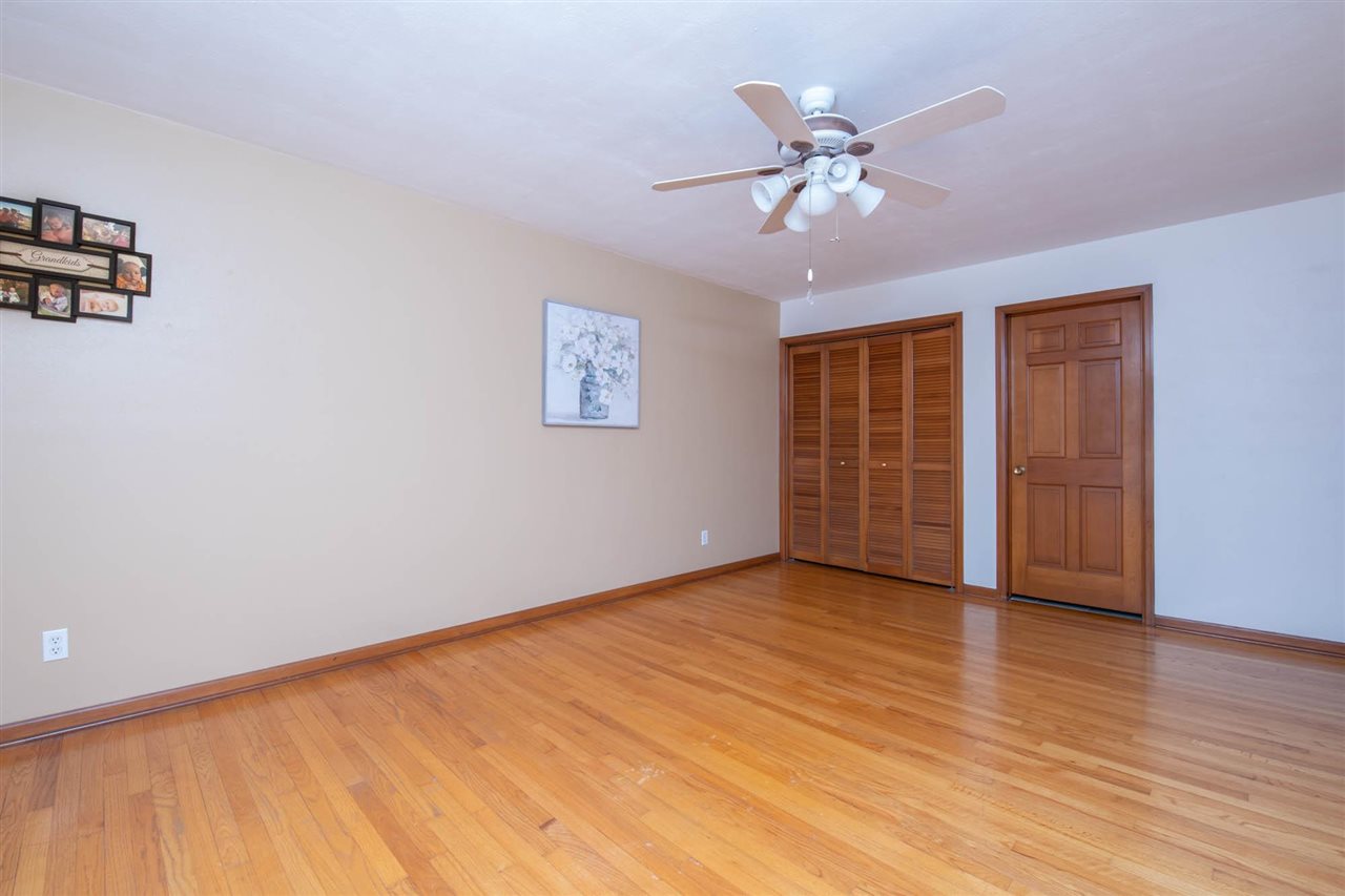 4960 Welsh Road Rockford, IL 61107 - Photo 19 of 39 an empty room with wooden floor closet and windows