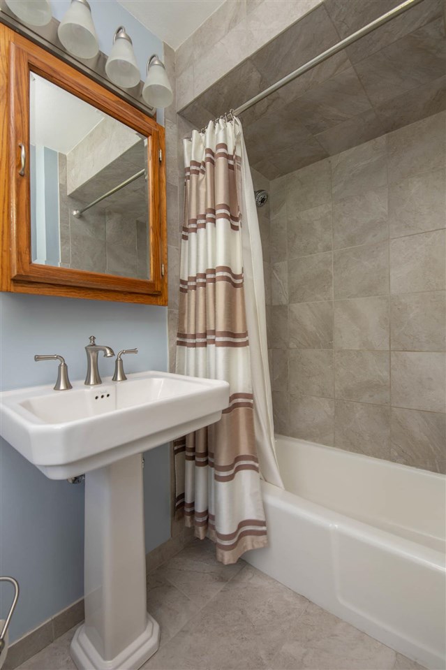 4960 Welsh Road Rockford, IL 61107 - Photo 21 of 39 a bathroom with a sink and a bathtub