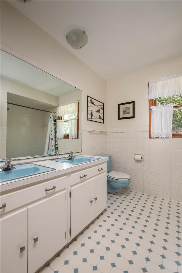 4960 Welsh Road Rockford, IL 61107 - Photo 25 of 39 a spacious bathroom with a double vanity sink mirror and toilet