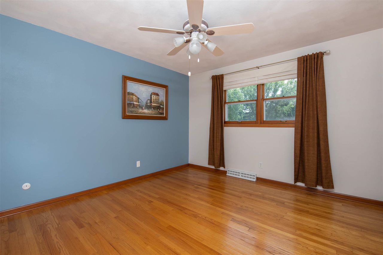 4960 Welsh Road Rockford, IL 61107 - Photo 29 of 39 a view of an empty room with window and wooden floor
