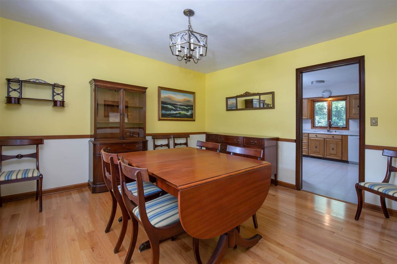 4960 Welsh Road Rockford, IL 61107 - Photo 7 of 39 a dining room with a table chairs and a wooden floor