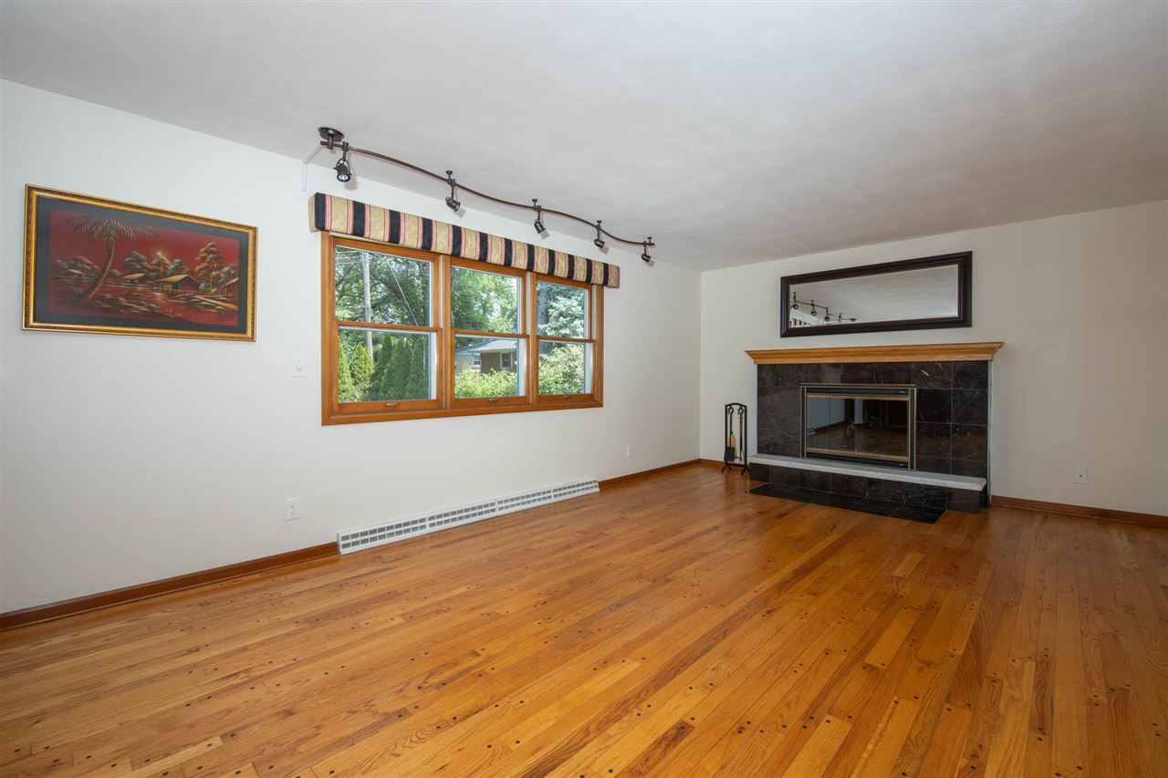 4960 Welsh Road Rockford, IL 61107 - Photo 9 of 39 a view of empty room with wooden floor and fireplace