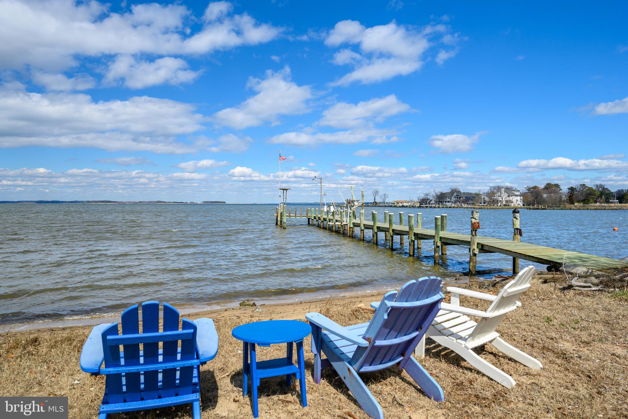 a view of a terrace with lawn chairs