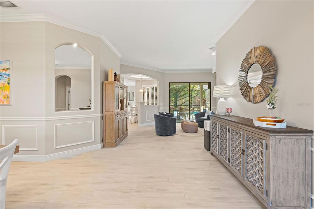 6470 Indigo Bunting Place Lakewood Ranch, FL 34202 - Photo 14 of 65 a living room with furniture a wooden floor and white walls