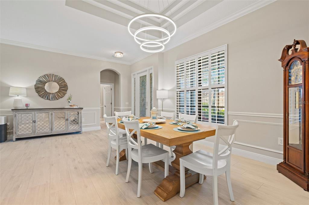 6470 Indigo Bunting Place Lakewood Ranch, FL 34202 - Photo 17 of 65 a view of a dining room with furniture and a large window