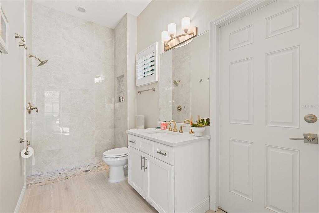 6470 Indigo Bunting Place Lakewood Ranch, FL 34202 - Photo 28 of 65 a bathroom with a sink a toilet and shower