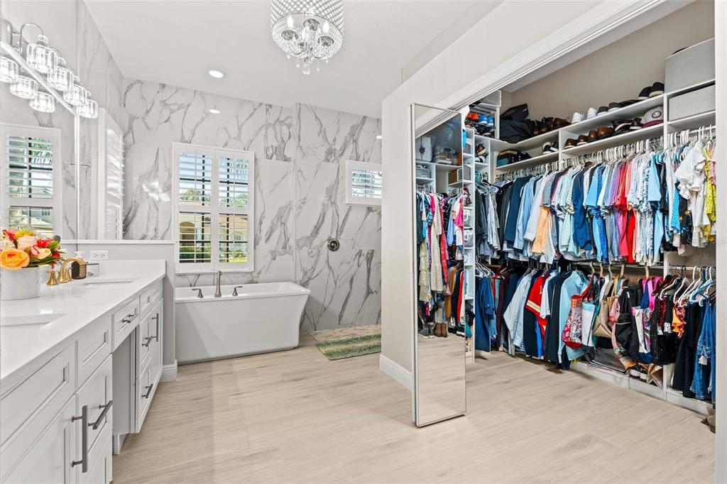 6470 Indigo Bunting Place Lakewood Ranch, FL 34202 - Photo 33 of 65 a view of walk in closet with clothes and shoes