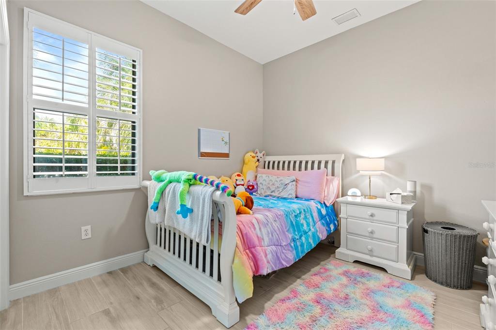 6470 Indigo Bunting Place Lakewood Ranch, FL 34202 - Photo 34 of 65 a bedroom with a bed and a table