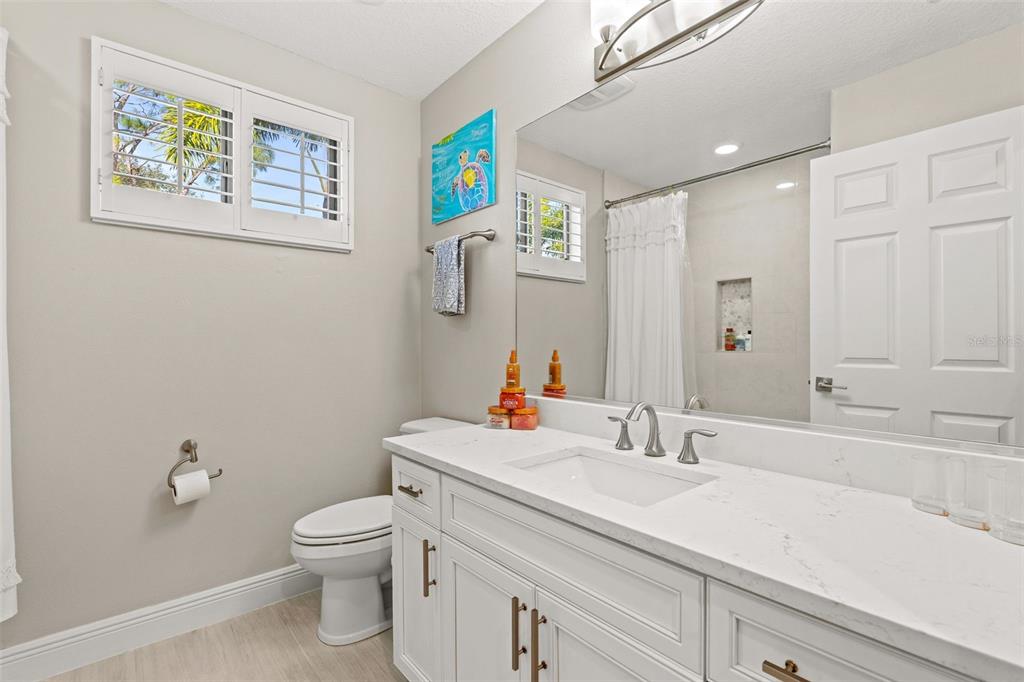 6470 Indigo Bunting Place Lakewood Ranch, FL 34202 - Photo 36 of 65 a bathroom with a sink mirror vanity and toilet