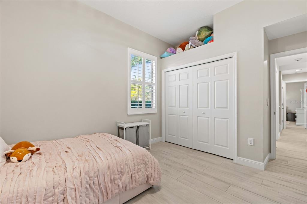 6470 Indigo Bunting Place Lakewood Ranch, FL 34202 - Photo 38 of 65 a bedroom with a bed and a window