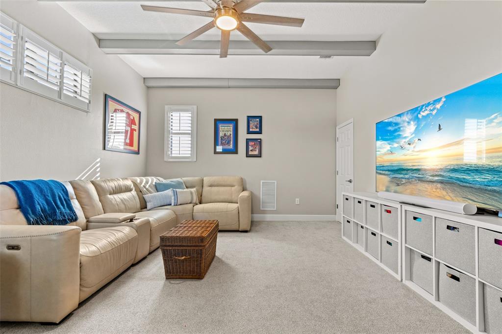 6470 Indigo Bunting Place Lakewood Ranch, FL 34202 - Photo 41 of 65 a living room with furniture a flat screen tv and a dresser