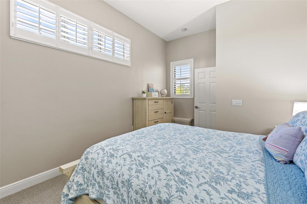 6470 Indigo Bunting Place Lakewood Ranch, FL 34202 - Photo 45 of 65 a bedroom with a bed and dresser