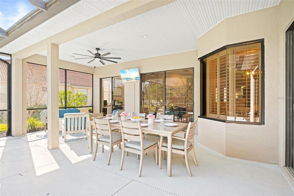 6470 Indigo Bunting Place Lakewood Ranch, FL 34202 - Photo 47 of 65 a view of a dining room with furniture large windows and wooden floor