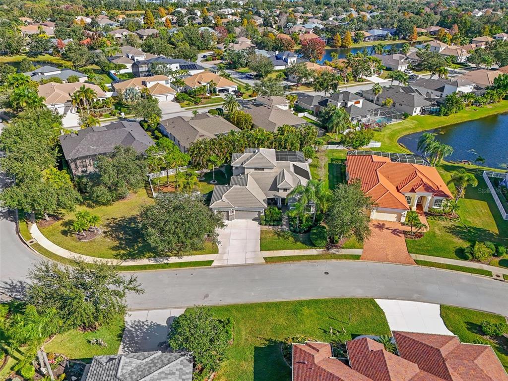 6470 Indigo Bunting Place Lakewood Ranch, FL 34202 - Photo 60 of 65 an aerial view of residential houses with outdoor space and swimming pool