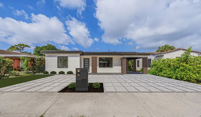 a front view of house with yard and green space