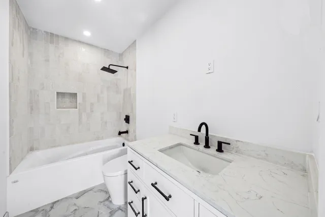 a bathroom with a sink a vanity and bathtub