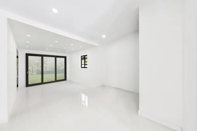a hallway with wooden cabinets and furniture