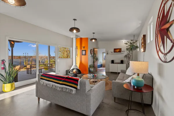 a view of a livingroom with furniture and floor to ceiling window
