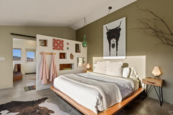 a bedroom with a bed and a window