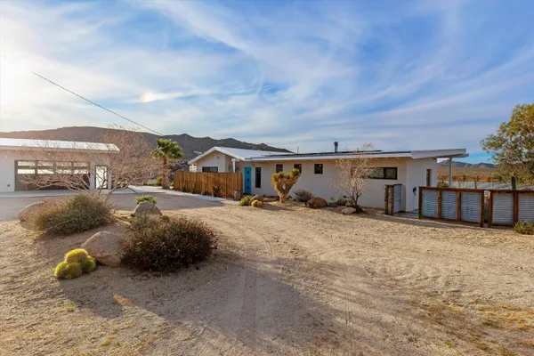 a view of backyard with cabin and wooden fence