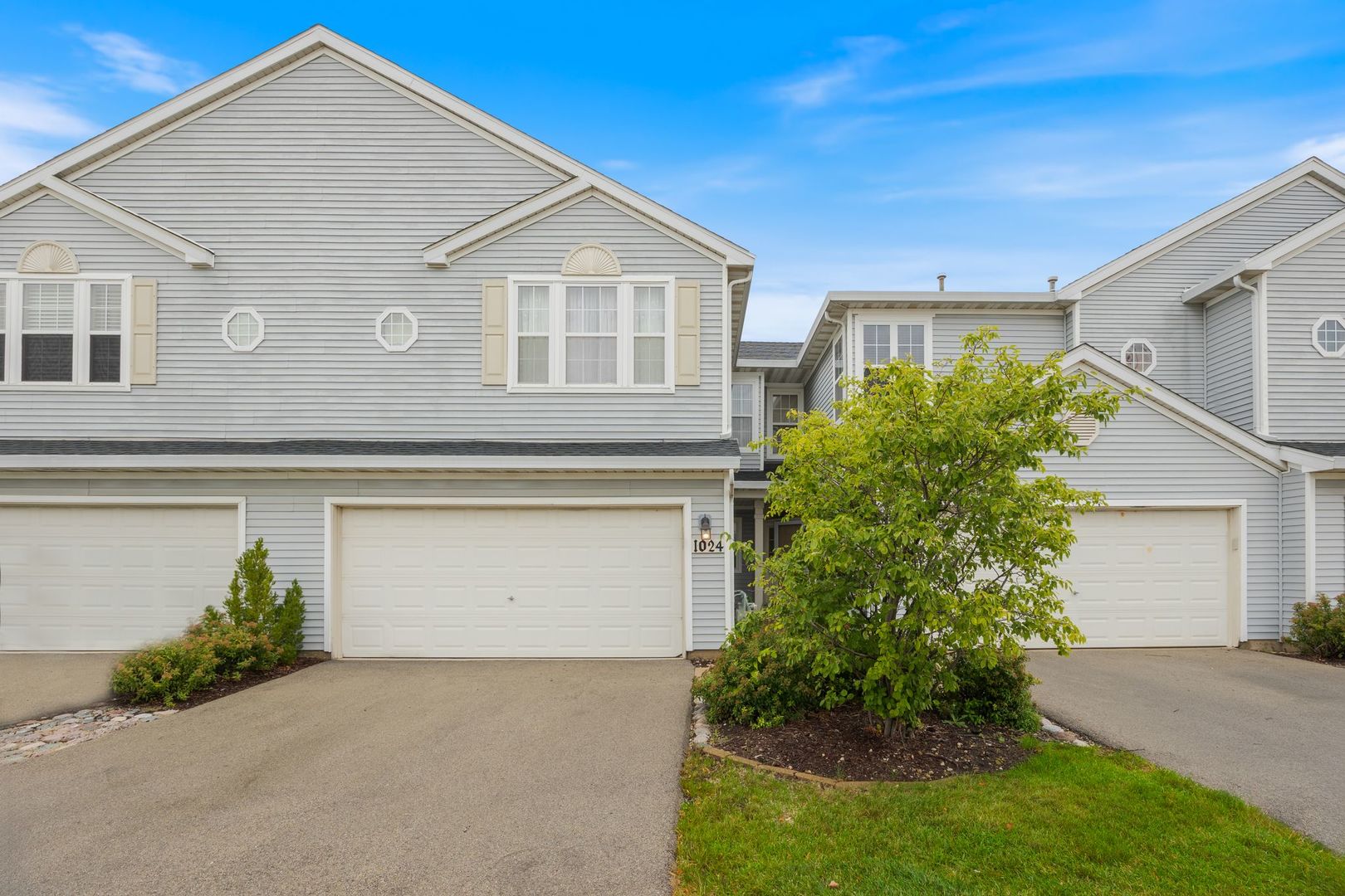 1024 Key Largo Drive Romeoville, IL 60446 - Photo 1 of 25 a front view of a house with garden