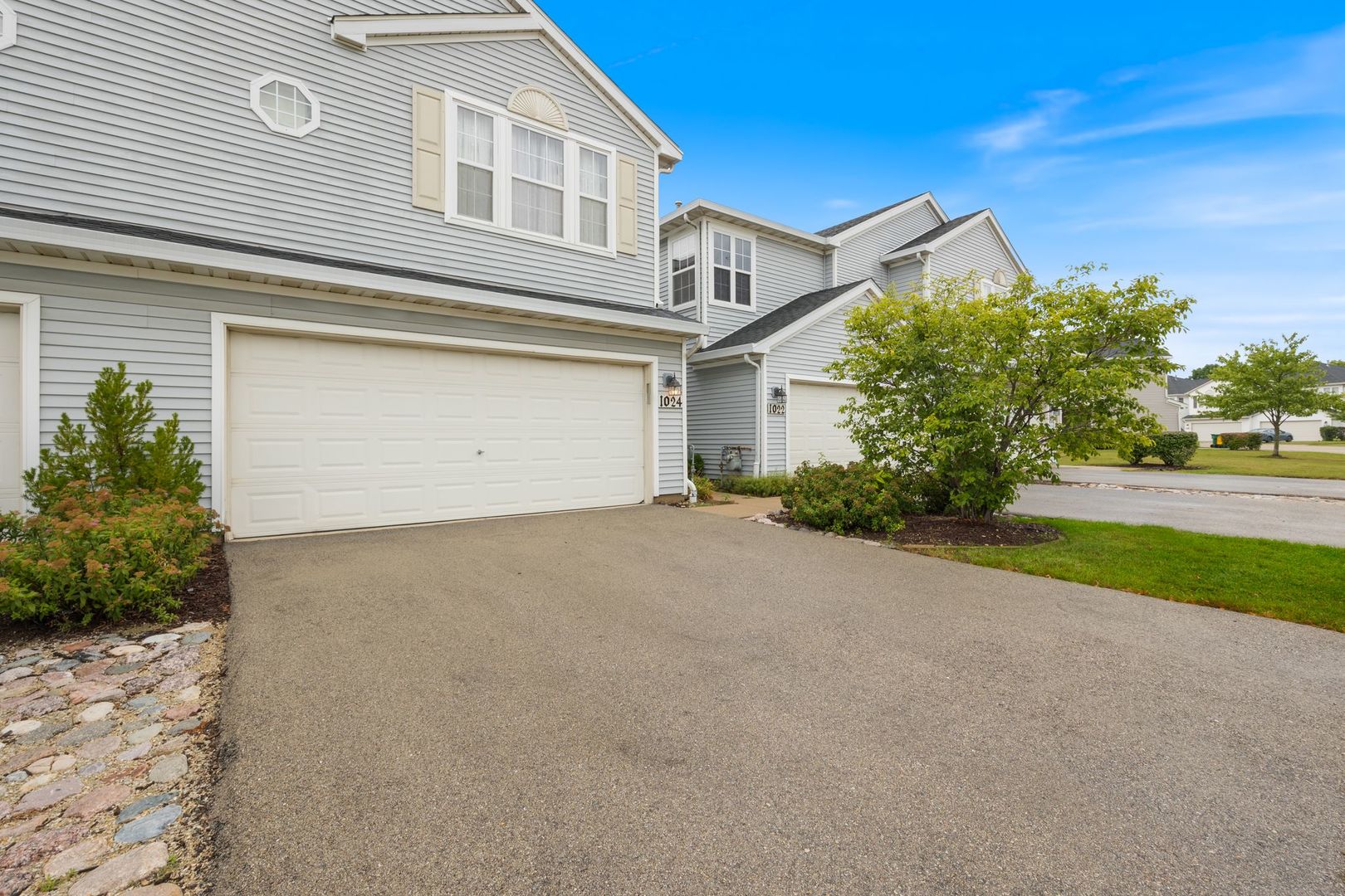 1024 Key Largo Drive Romeoville, IL 60446 - Photo 22 of 25 a front view of a house with a yard and garage