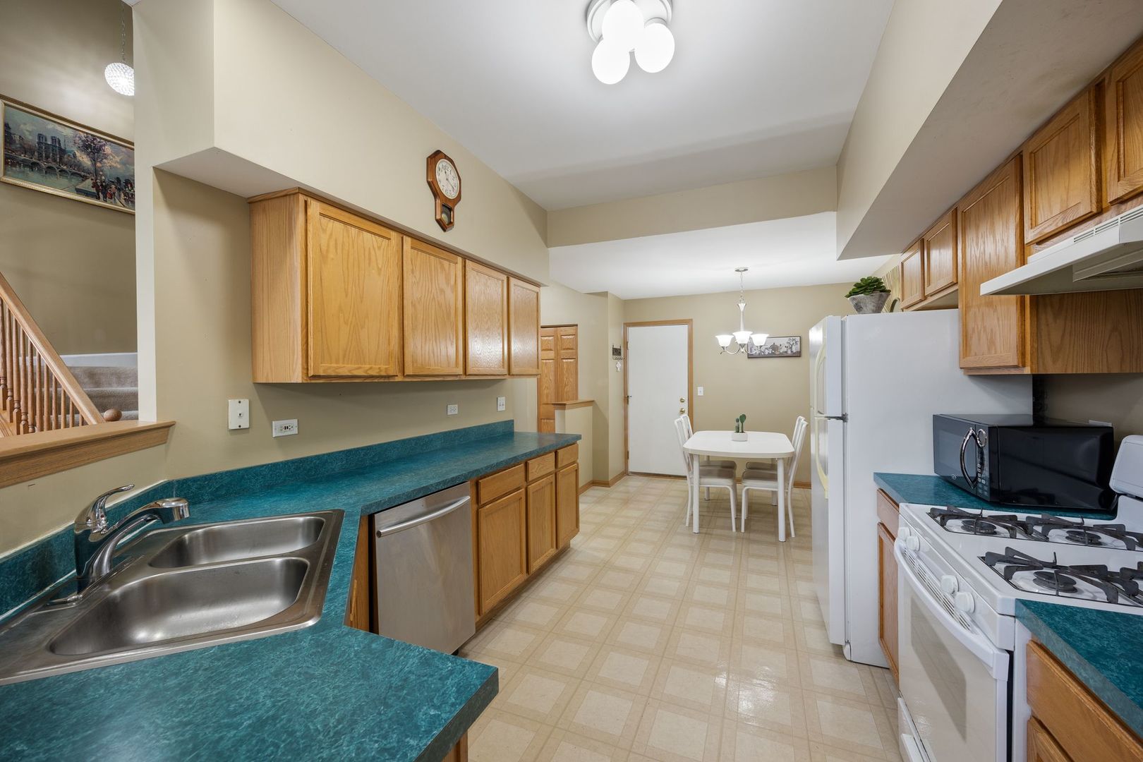 1024 Key Largo Drive Romeoville, IL 60446 - Photo 7 of 25 a kitchen with kitchen island granite countertop a sink and a stove top oven
