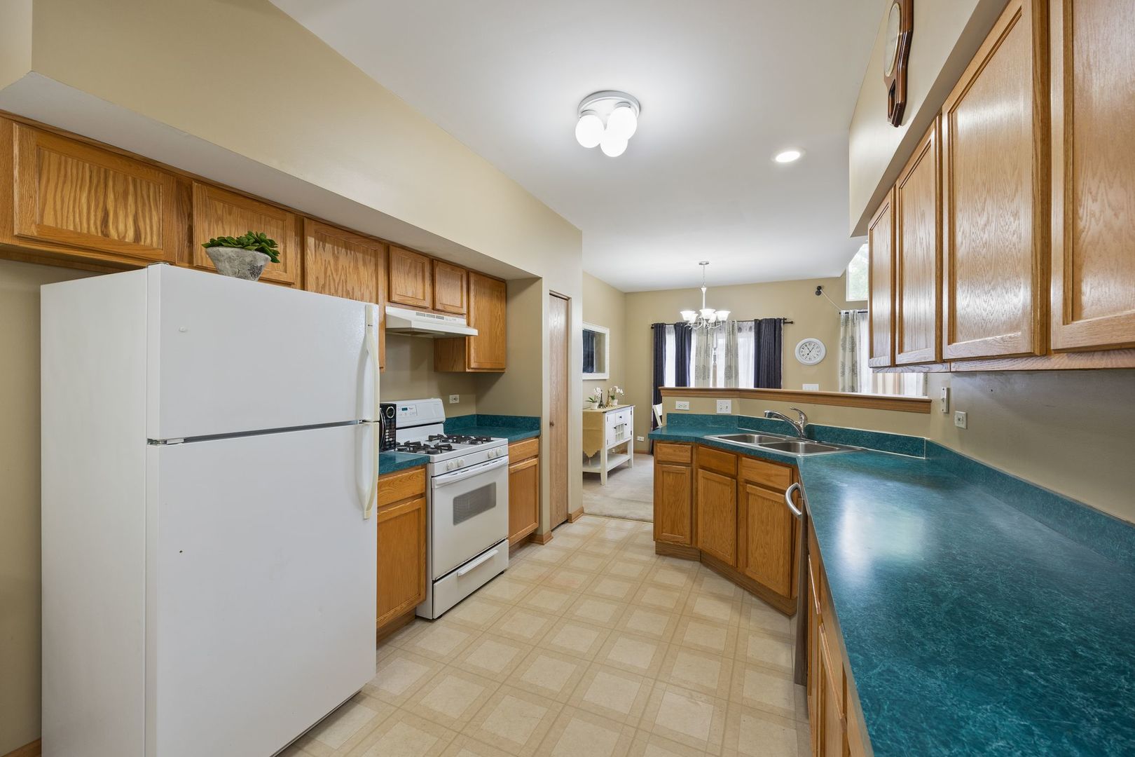 1024 Key Largo Drive Romeoville, IL 60446 - Photo 8 of 25 a kitchen with stainless steel appliances granite countertop a refrigerator a stove and a sink
