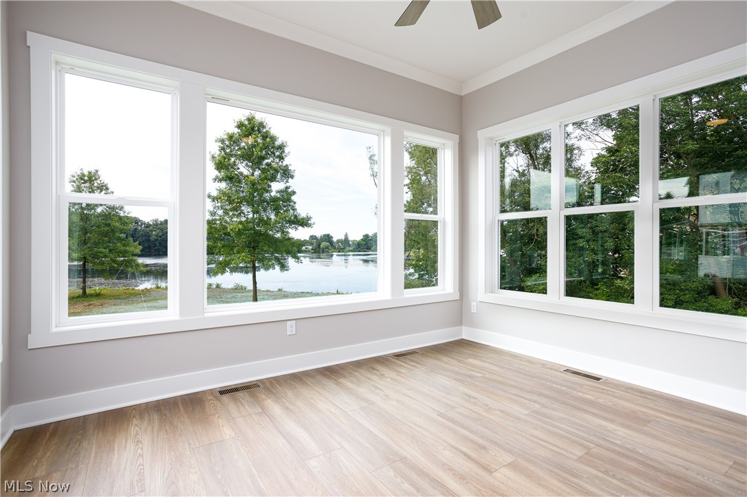 5796 Springlake Road Northwest Canton, OH 44718 - Photo 26 of 50 Unfurnished sunroom with ceiling fan and a water view