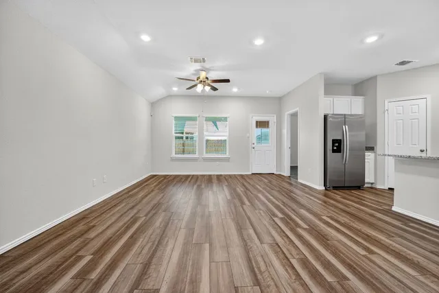 a kitchen with stainless steel appliances granite countertop a refrigerator sink and stove