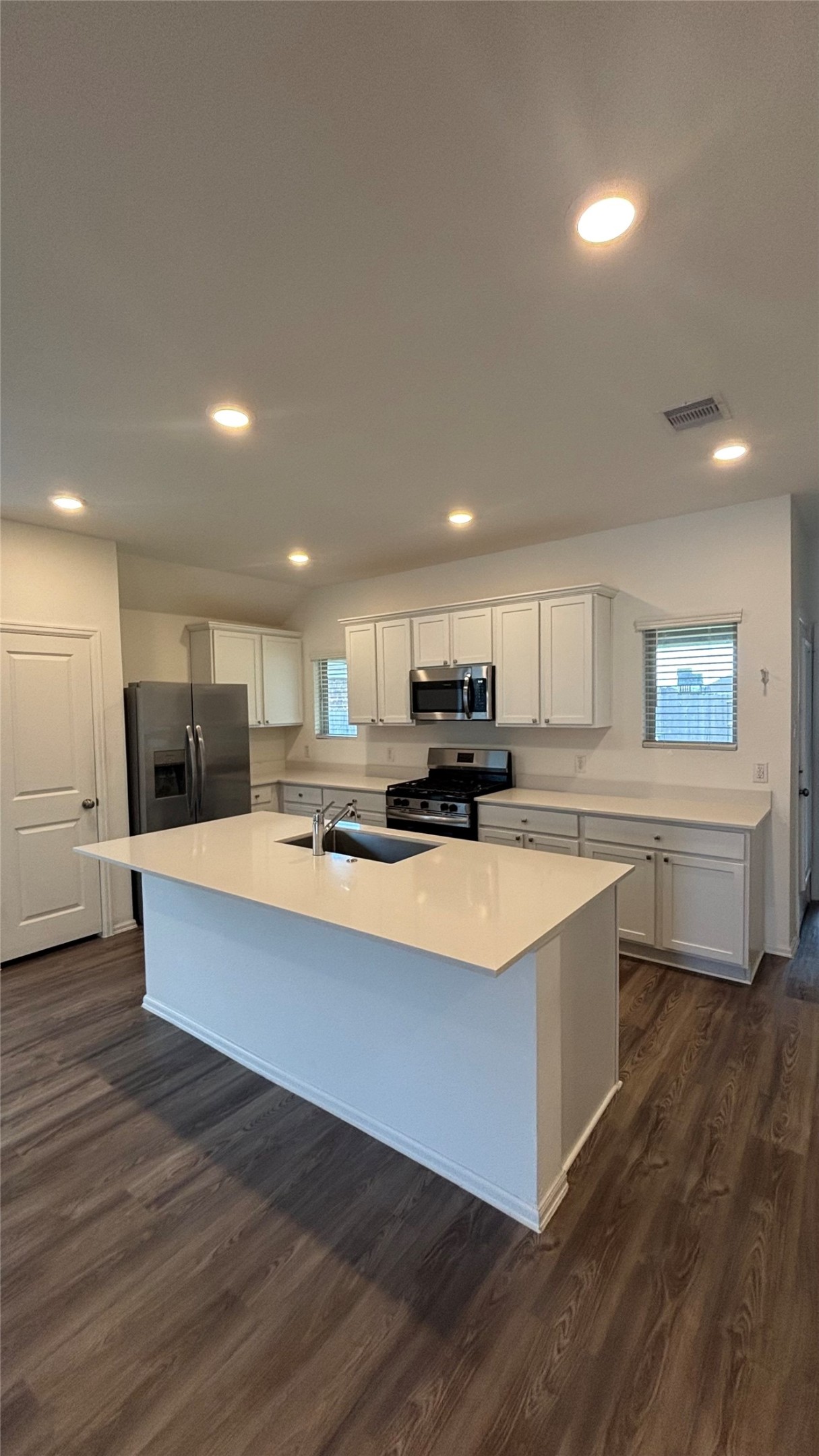 4314 Liberty Ranch Way Baytown, TX 77521 - Photo 4 of 29 a large white kitchen with kitchen island a sink a stove a refrigerator and a stove