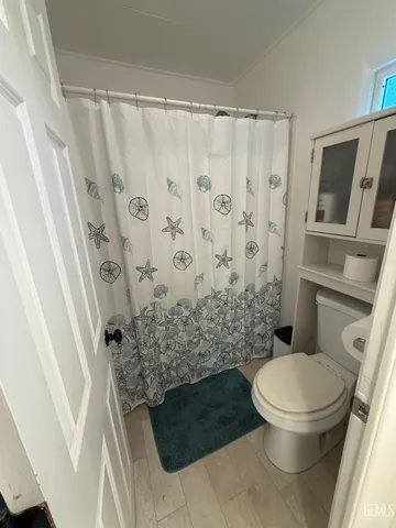 a bathroom with a toilet and a shower