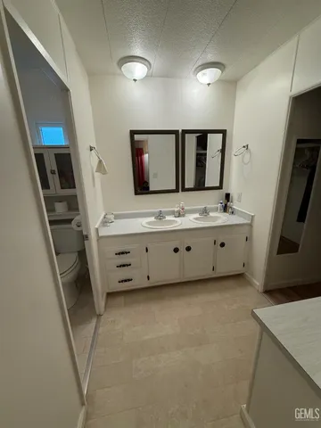 a bathroom with double vanity sink and mirror