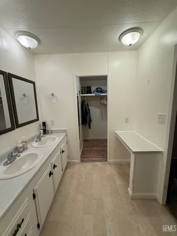 a bathroom with a double vanity sink and a mirror