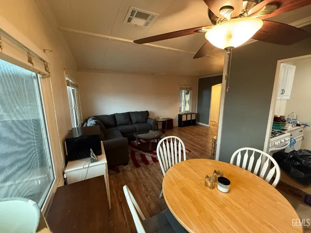 a view of a dining room with furniture and wooden floor