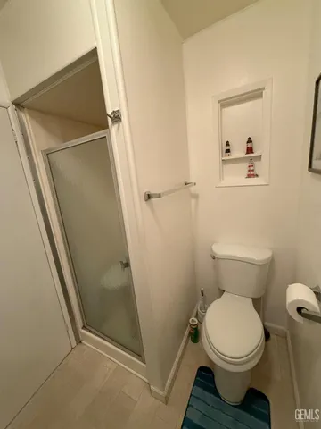 a bathroom with a toilet and a shower