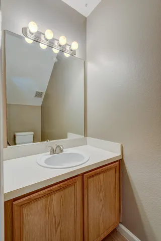 a bathroom with a sink vanity and a mirror