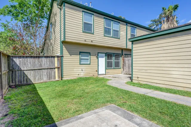 a front view of a house with a yard and outdoor seating