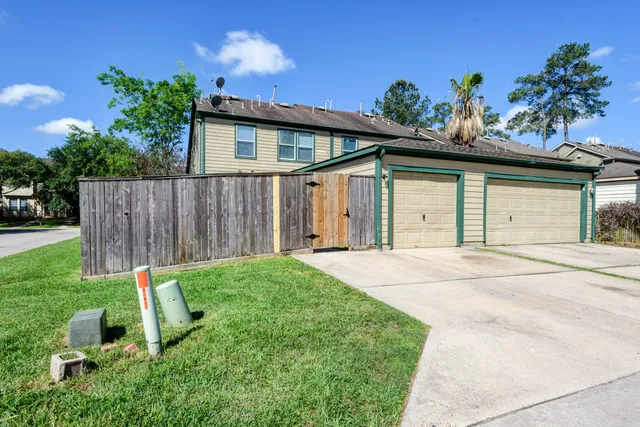 a white house with a yard and plants