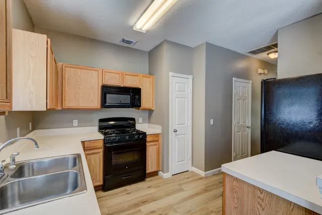 a kitchen with a sink and a stove top oven