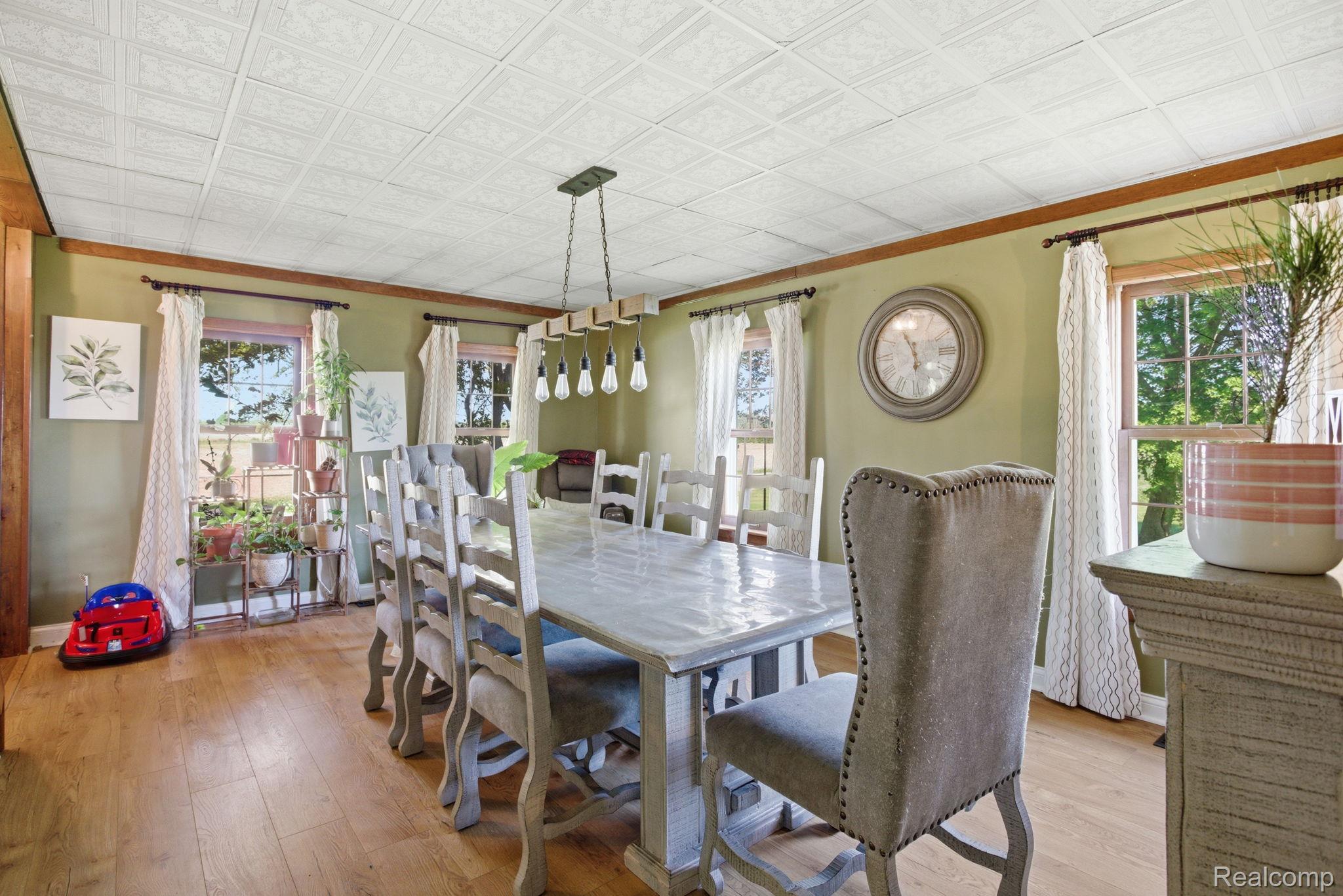 14104 Carleton West Road Carleton, MI 48117 - Photo 25 of 58 Dining room with light wood-style floors and an ornate ceiling