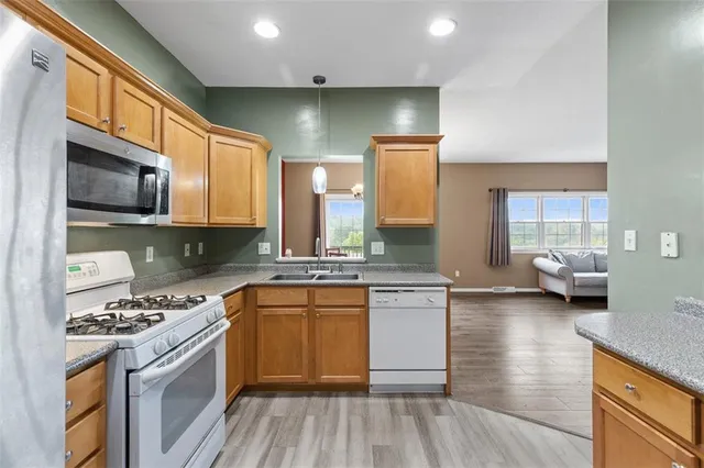 a kitchen with stainless steel appliances a sink stove and cabinets