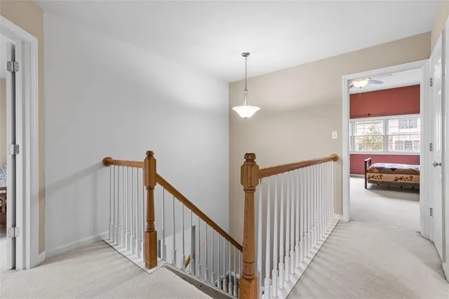 a view of a hallway to a livingroom and a bedroom with furniture