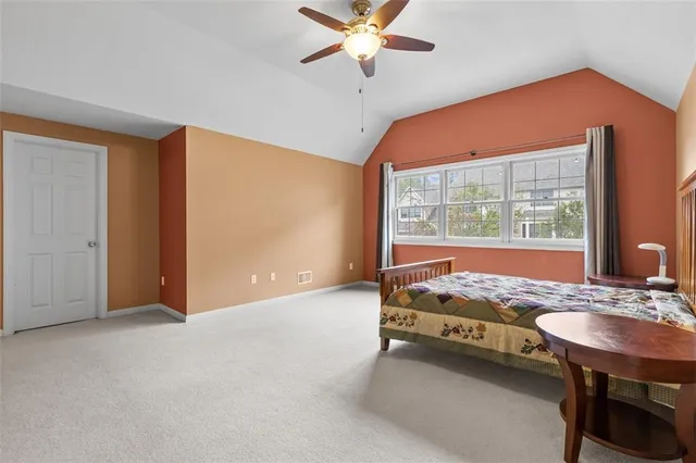 a spacious bedroom with a bed and a table