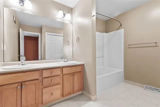 a bathroom with a tub sink and mirror