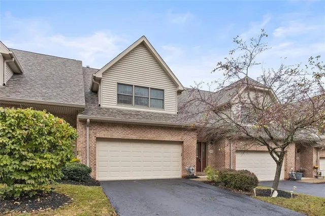 a view of a house with a yard and garage