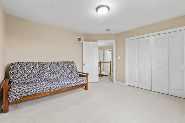 a spacious bedroom with a bed and a window