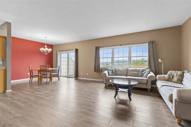 a living room with furniture and a table with wooden floor